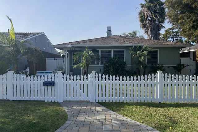 Her front yard before the work, photographed on a phone