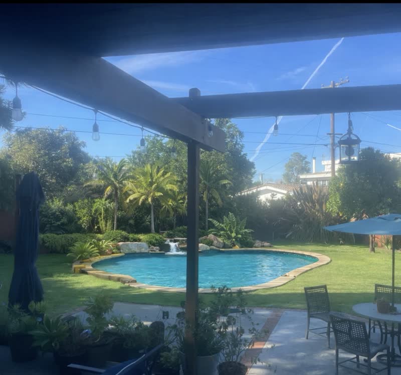 The same backyard rendered with a tropical pool